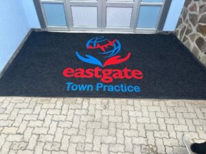 Oshakati Retail Entrance — Full-colour logo, premium coir